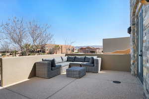 View of front patio and an outdoor living space