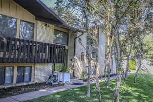 View of home's exterior with a yard and brick siding