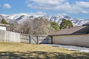 View of yard featuring fence and a mountain view