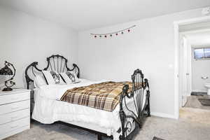 Carpeted bedroom with baseboards