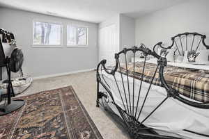 Bedroom featuring a closet, carpet flooring, visible vents, and baseboards