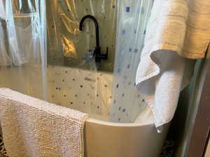 Bathroom featuring a freestanding soaking tub and a showe