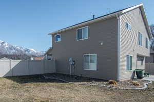 Rear view of property featuring fence and a mountain view