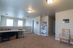 Carpeted office space featuring baseboards