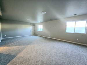 Carpeted spare room with baseboards