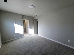 Unfurnished room with light carpet and baseboards