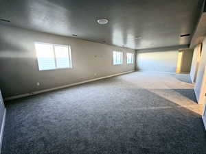 Carpeted empty room with baseboards