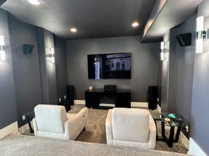 Home theater room with recessed lighting, carpet, and baseboards