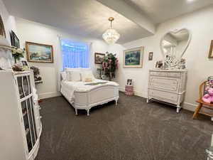 Bedroom featuring a chandelier,  carpet,