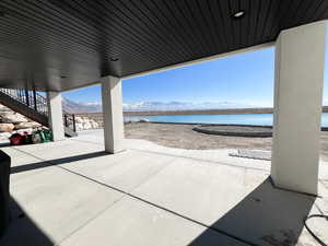 View of patio / terrace with stairs and a water and mountain view