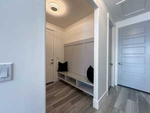 Mudroom featuring LVP floors and a built in bench