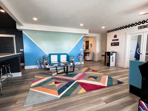 Rec room with baseboards, wood finished floors, and recessed lighting