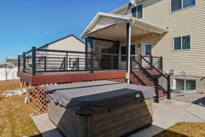 Exterior space with a hot tub and a deck