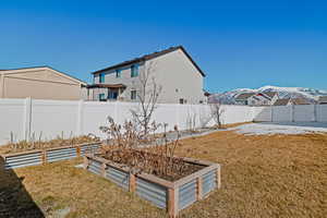 View of yard with a fenced backyard and a garden