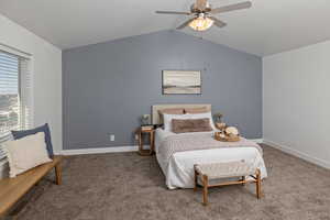 Bedroom featuring carpet floors, lofted ceiling, baseboards, and a ceiling fan