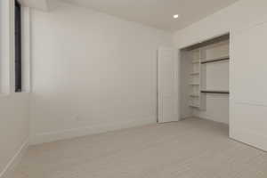 Unfurnished bedroom featuring a closet, recessed lighting, carpet flooring, and baseboards