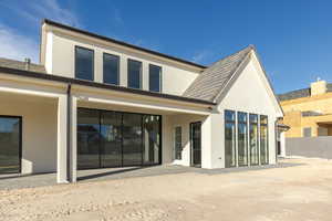 Back of house featuring fence and stucco siding