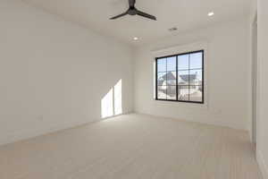 Empty room with recessed lighting, visible vents, ceiling fan, and carpet flooring