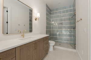 Full bath featuring a stall shower, tile patterned flooring, vanity, and toilet