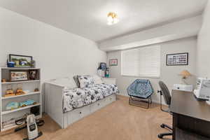 Carpeted bedroom with baseboards