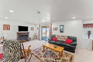 Living area with carpet floors, recessed lighting, and baseboards