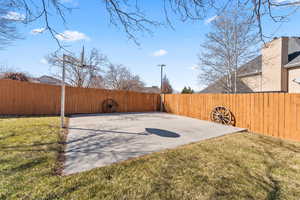 View of sport court featuring a yard and a fenced backyard