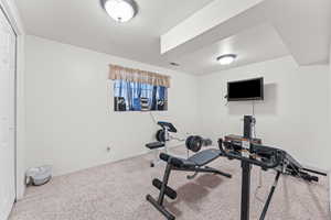 Exercise area with carpet floors and baseboards