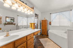 Full bathroom featuring vanity and a whirlpool tub