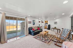 Carpeted living area with recessed lighting