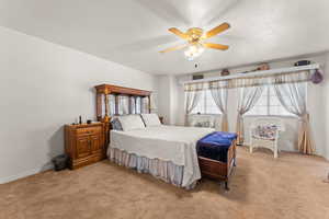 Master Bedroom featuring light carpet, visible vents, baseboards, and a textured ceiling