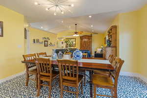 Dining room with lofted ceiling, ceiling fan and recessed lighting