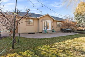 Back of property with a patio and yard