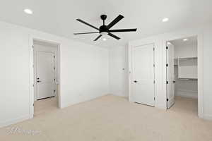 Unfurnished bedroom featuring baseboards, a spacious closet, carpet flooring, and recessed lighting