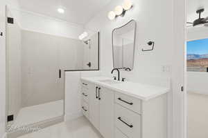 Full bath featuring a shower stall, ceiling fan, tile patterned flooring, and vanity