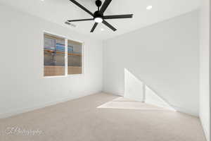 Spare room featuring ceiling fan, recessed lighting, visible vents, baseboards, and carpet