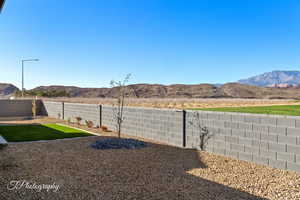 View of yard with a fenced backyard and a mountain view