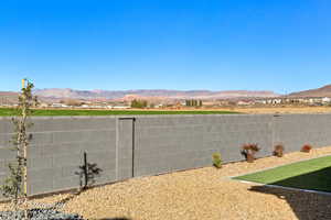 View of yard with a fenced backyard and a mountain view