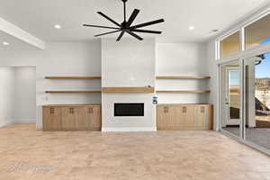 Unfurnished living room featuring a fireplace, recessed lighting, ceiling fan, a textured ceiling, and baseboards