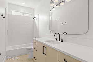 Full bath featuring toilet, bathing tub / shower combination, and vanity