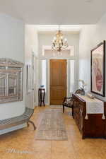 Entrance foyer featuring an inviting chandelier and light tile patterned floors