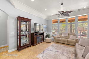 Living room with light tile patterned floors, baseboards, arched walkways, ceiling fan, and recessed lighting