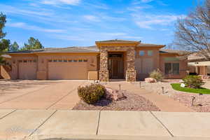 Prairie-style home featuring driveway, an attached garage, and stucco siding