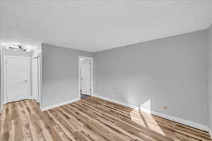 Unfurnished room with light wood-style floors and baseboards