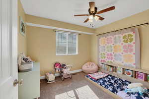 Bedroom featuring carpet, baseboards, and ceiling fan