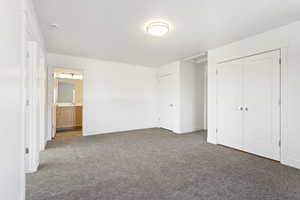 Unfurnished bedroom featuring carpet flooring and baseboards