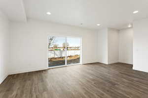 Spare room with baseboards, wood finished floors, and recessed lighting