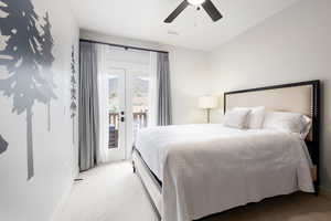 Carpeted bedroom with ceiling fan, visible vents, baseboards, access to exterior, and french doors