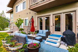 View of patio with an outdoor hangout area and grilling area