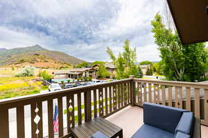 Balcony featuring a residential view and a mountain view