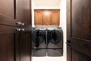 Laundry room featuring cabinet space and washing machine and clothes dryer